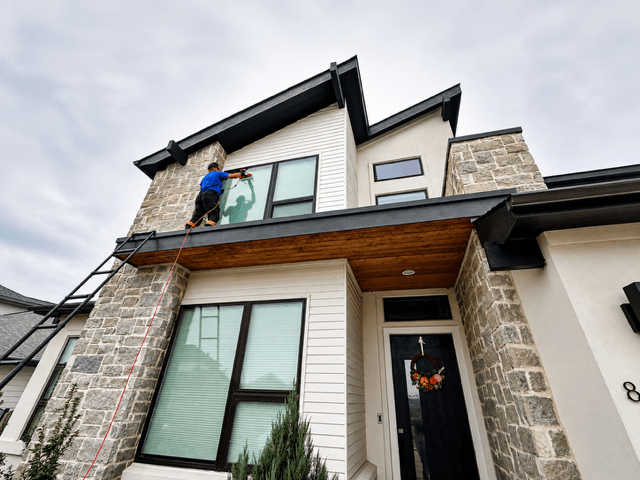 Exterior window cleaning on a modern Austin home